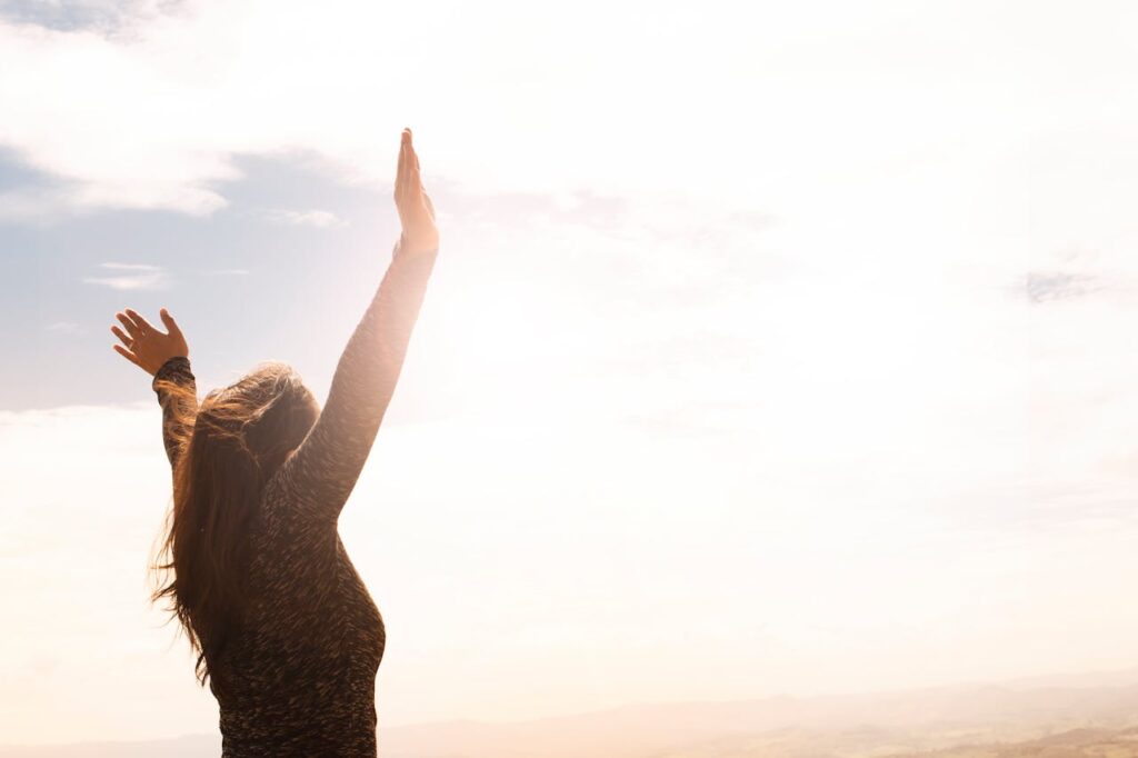 photo-of-woman-raising-both-hands-1556691